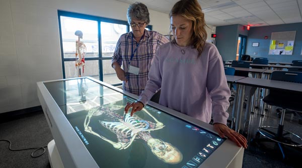 LCRCWC healthcare teacher and student with digital operating table.