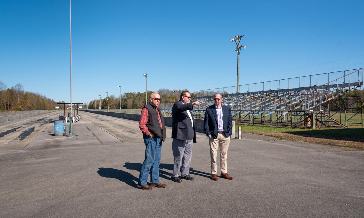 RCIDA board member Scott Pierce, Russell County Judge Executive Gary Robertson, and RCIDA Executive Director Bennie Garland inspect the drag strip after the deed transfer.