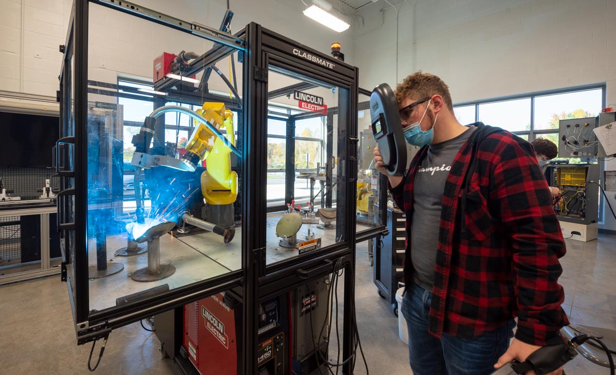 Student controlling robotic welder at the Lake Cumberland Regional College and Workforce Center